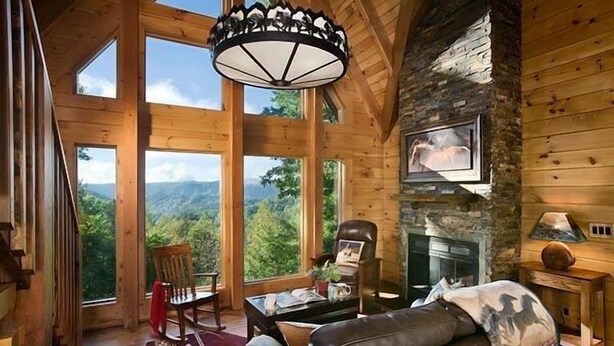 A spacious living room with large windows, a stone fireplace, and a cozy seating area. - Romantic Cabin,Views,Pet-Friendly,Trails (Ferguson)