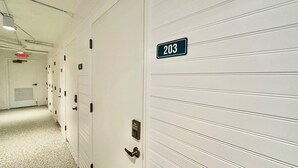 A hallway with doors numbered 203 and 304, featuring a combination lock and a keyhole.