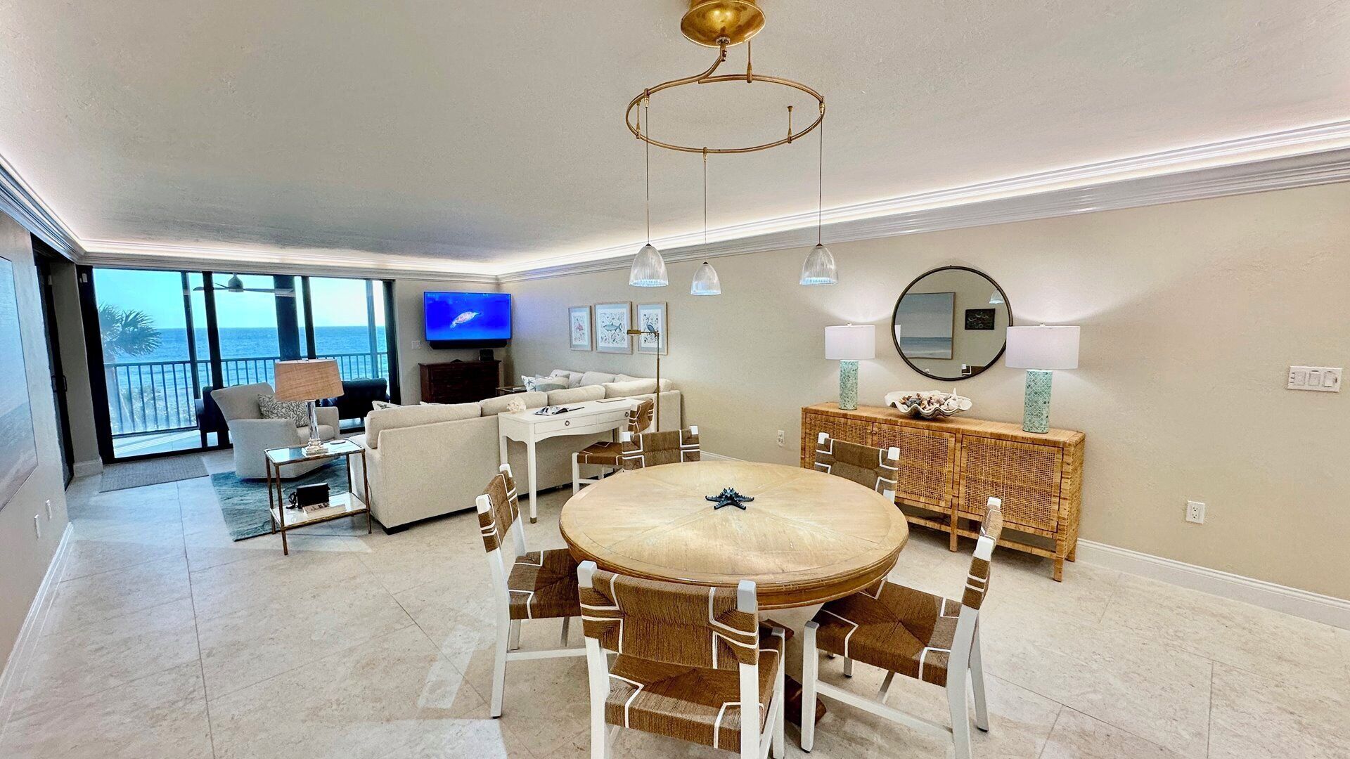A modern living room with a round dining table, a sofa, and a TV.