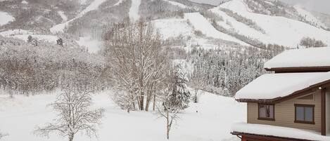 A snow-covered mountain landscape with a cabin.
