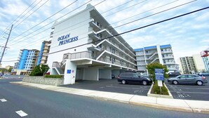 A multi-story hotel named "Ocean Princess" with a modern architectural design, featuring balconies and a parking area. - Ocean Princess 207-Oceanside 134th St, Elev, W/D, AC (Ocean City)