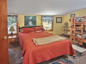 A bedroom with a bed, two nightstands, a wooden ladder, and a window with curtains. - Valley View Cottage - Quiet Cabin w/Firepit near Deep Creek and downtown + free railroad tix (Bryson City)