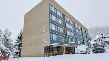 A modern building with a large entrance and multiple windows.