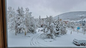 A snowy landscape with trees and a road. - Summit House Short Walk to Skiing, Covered Parking Balcony w/ Panoramic Views (Copper Mountain)