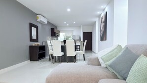Ein modernes Wohnzimmer mit einer Couch, einem Couchtisch und einem Fernseher.