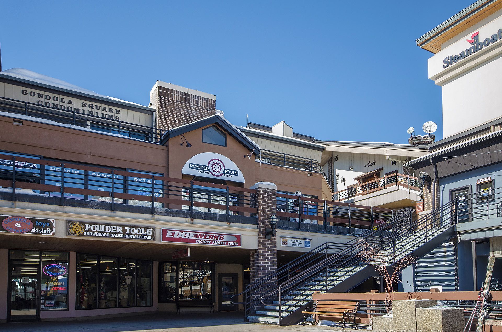 A multi-story shopping area with various retail stores, including a powder tools shop and a ski club.