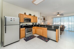 Enjoy cooking in this well-equipped kitchen with a refrigerator, microwave, and oven.