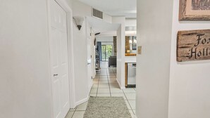 A hallway leading to a kitchen with a rug on the floor and a sign that reads "Fox Hollow". - three bedroom condo with loft, sleeps 8 (Gatlinburg)
