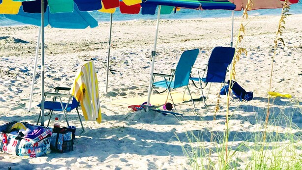 A beach with colorful umbrellas and beach chairs. - Bright And Beachy (Sanibel)