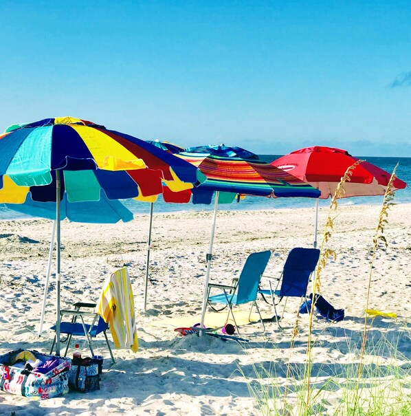 On the beach, beach umbrellas, beach towels - Bright And Beachy (Sanibel)