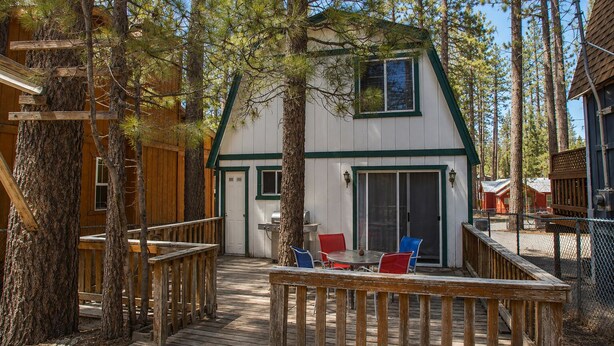 A cabin with a deck, outdoor seating, and a grill area. - Bear 'n Tree - Walk to Lake & Village, Fireplace, Barbecue (Big Bear Lake)