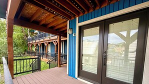 A wooden deck with a glass door and a blue wall. - Managed by Park City Lodging-One Block to Park City Mtn's Quit'N Time Ski Run (PARK CITY)