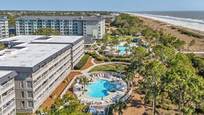A hotel with multiple floors, a rooftop pool, and a beach view. - Oceanfront Paradise! Heated Beachside Pool (Hilton Head)