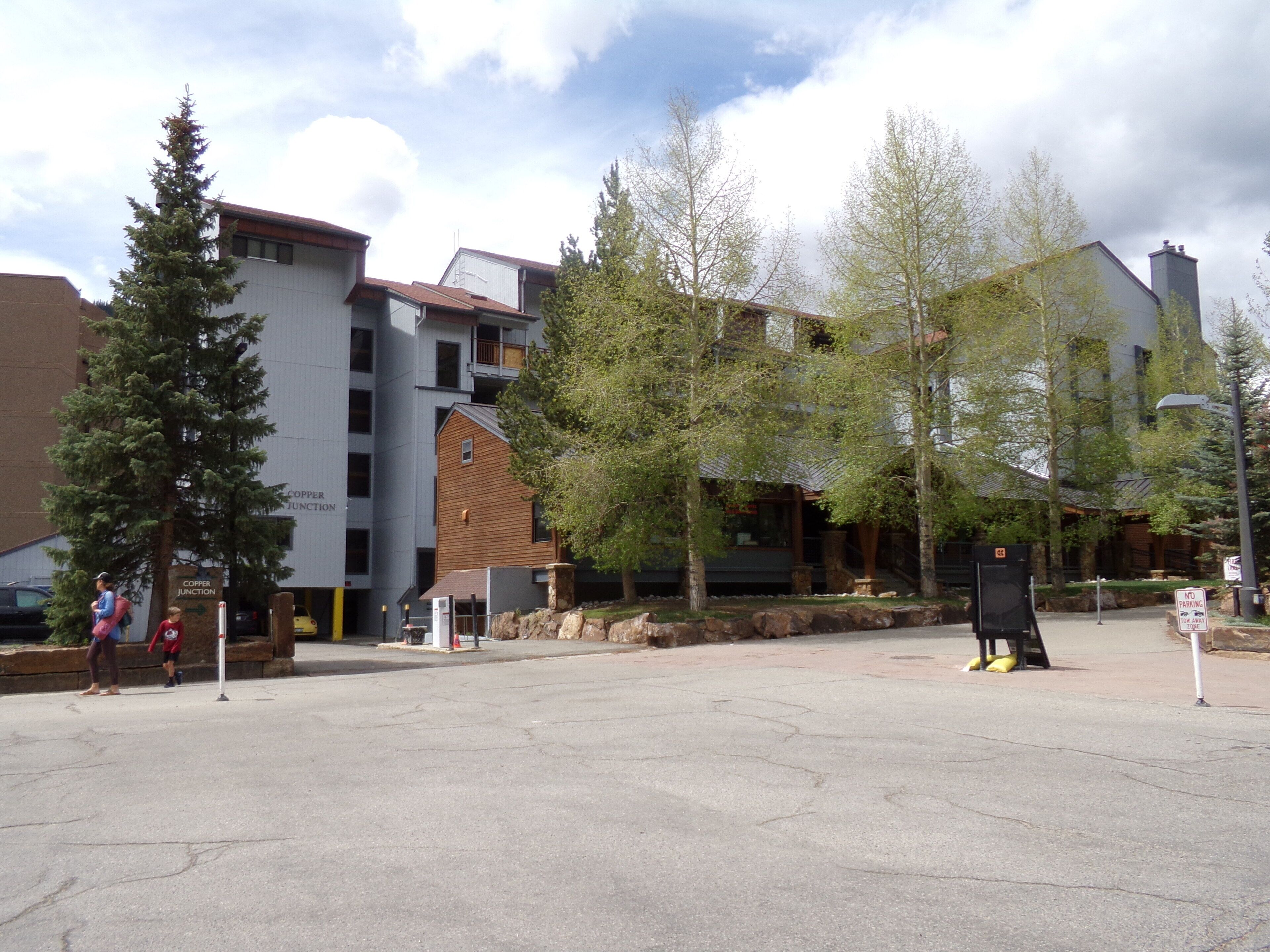 A building with a modern architectural style, featuring a mix of brick and wood exteriors, and a flat roof.