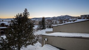 A snowy residential area with houses and a mountain in the background. - BT204 | Nicely Updated Condo | Great Views | Ski Locker | Ski In (Steamboat Springs)