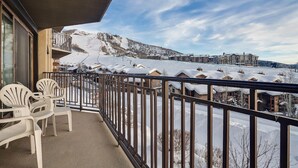 A balcony with a view of a snow-covered mountain and a ski resort in the background. - BT204 | Nicely Updated Condo | Great Views | Ski Locker | Ski In (Steamboat Springs)