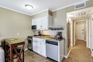 Enjoy cooking in this well-equipped kitchen with a central island, sink, microwave, and dishwasher.