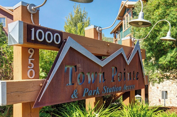 A wooden sign with 'Town Pointe & Park Station Access' and numbers '1000' and '950' indicating a location.