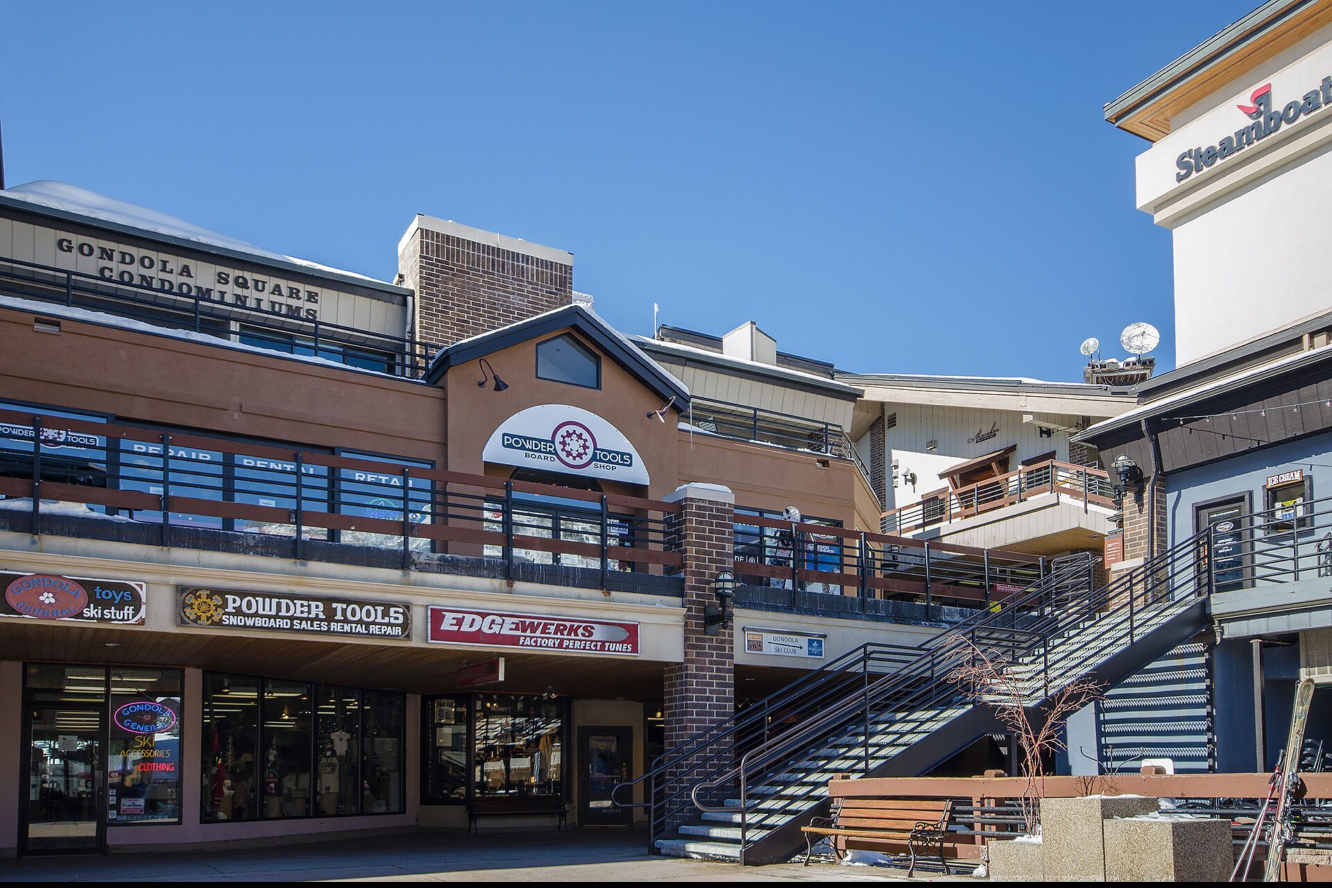 A multi-story shopping area with various retail stores, including a powder tools shop and a ski club.