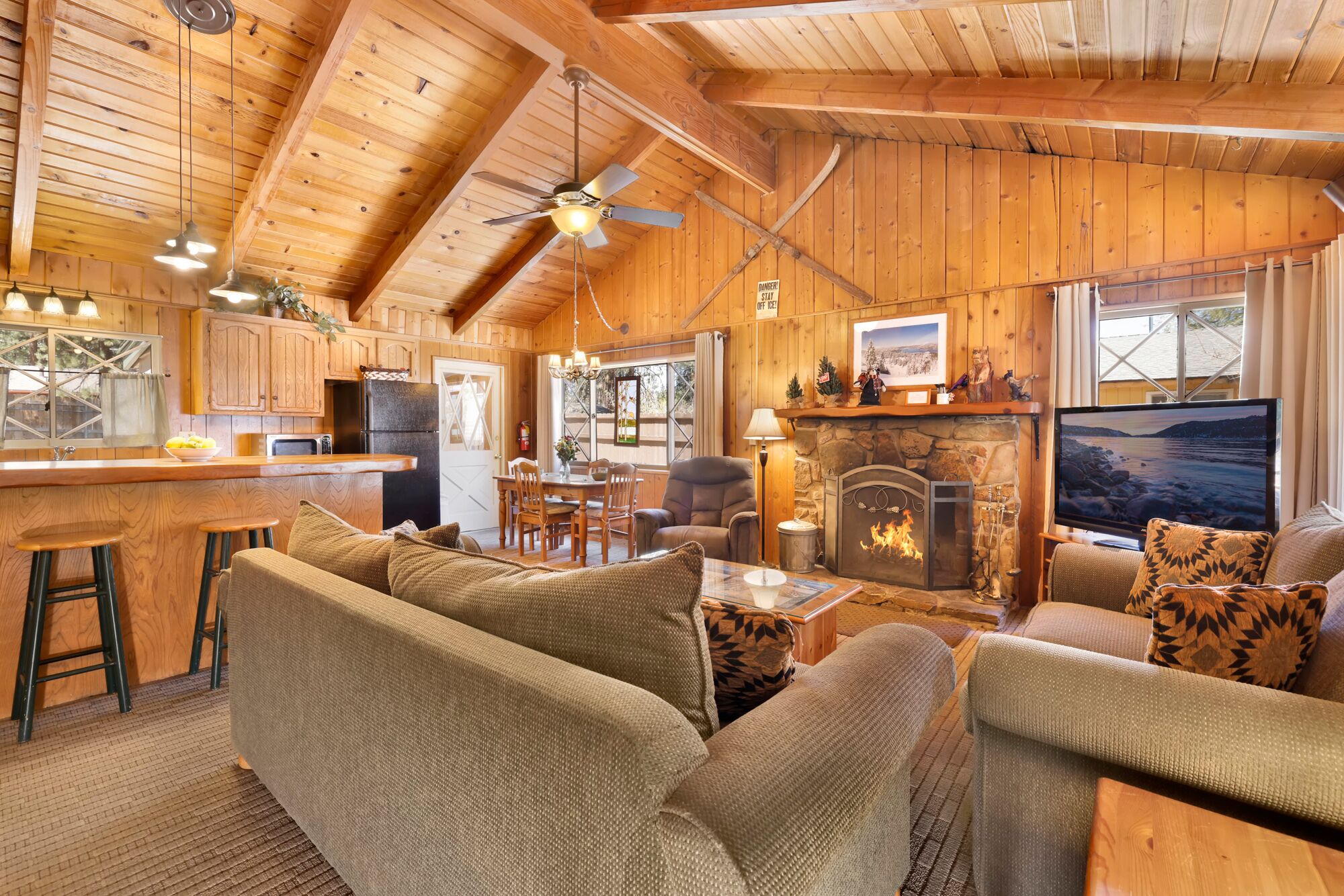 Cozy fireplace warms the open living room flowing into the kitchen, perfect for gatherings