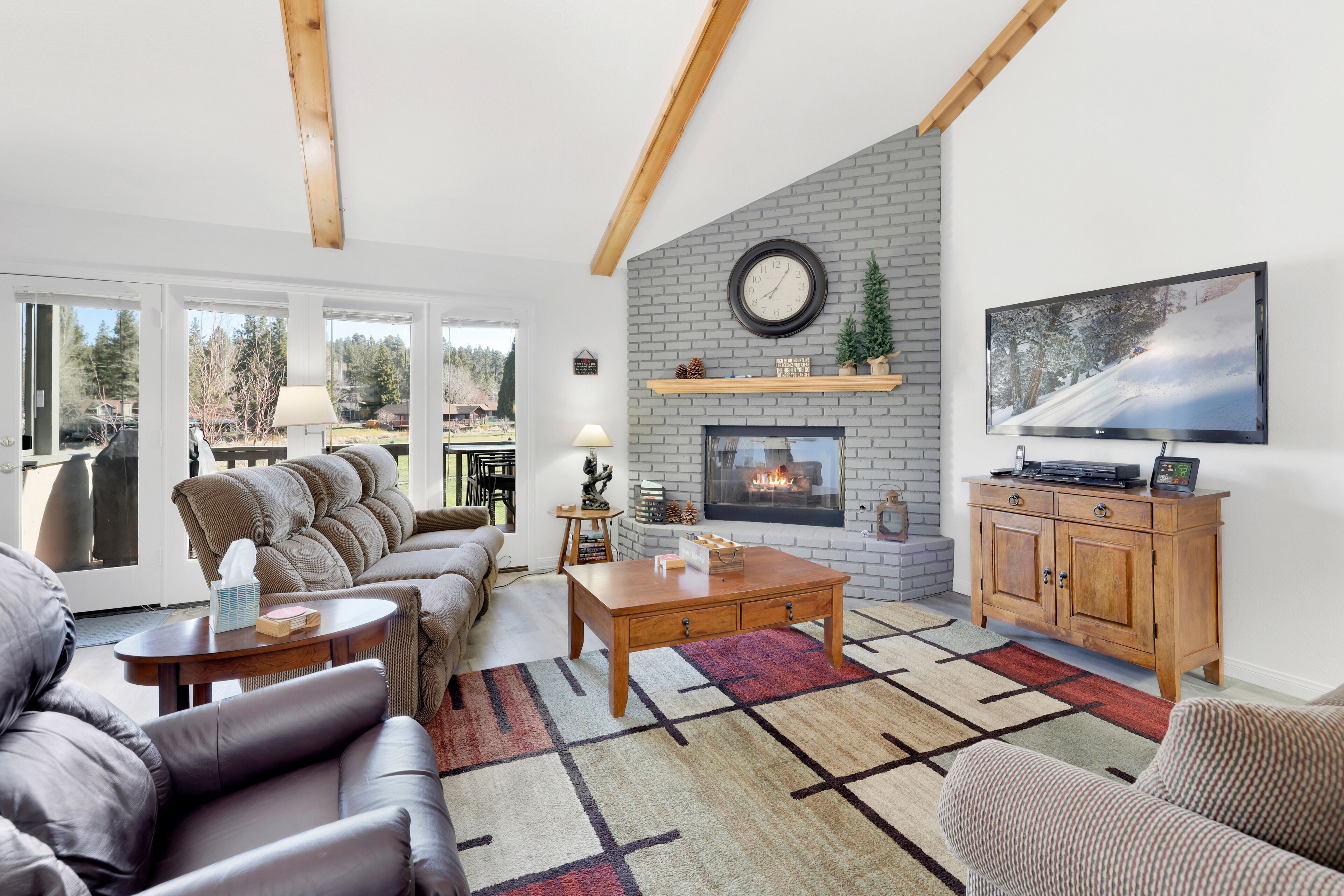 Bright and inviting living room featuring vaulted ceilings, exposed wood beams, cozy fireplace, and comfortable seating perfect for relaxing after a day exploring the mountains.
Tags: Living Room, Fireplace, Seating Area, Open Concept