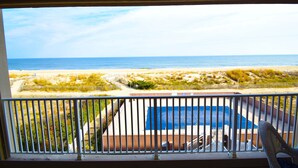 A balcony with a view of the beach and a pool area. - Beachmark 3F-Oceanfront 73rd St, WIFI, Pool, Elev, W/D, AC (Ocean City)