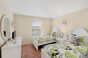 A bedroom with two beds, a dresser, a mirror, and a window with blinds. - Paradise Palms Resort 4 Bedroom Townhome Pet Friendly (Kissimmee)