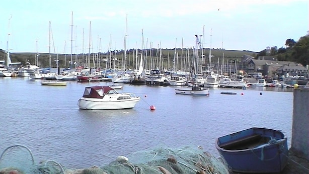 A marina with multiple boats docked.