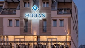 A hotel named SULTAN with a modern design, featuring balconies and a prominent logo. - Sultan Modern Hotel (Skopje)