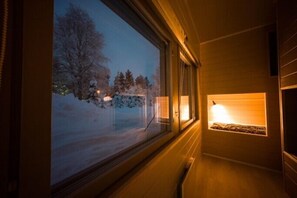 A corridor with a large window revealing a snowy landscape outside.