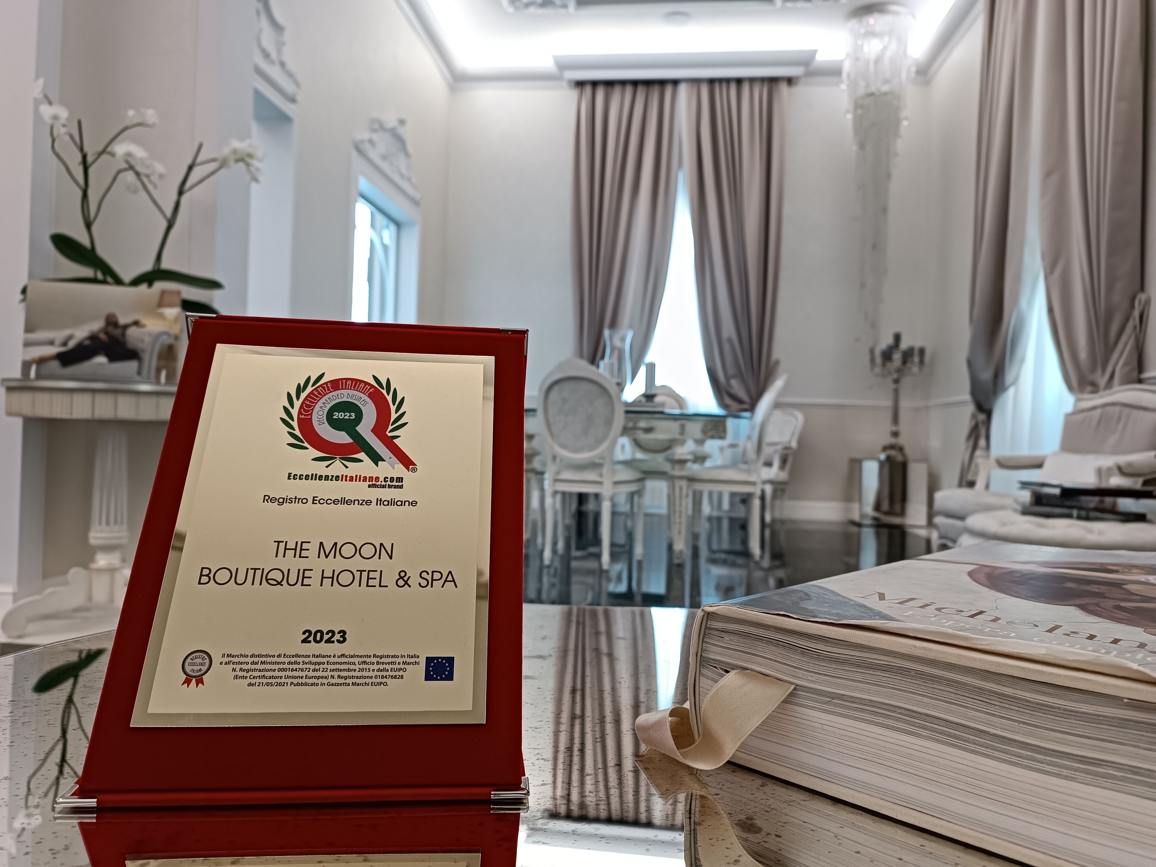 A framed award certificate for The Moon Boutique Hotel & SPA, indicating a 2023 recognition.