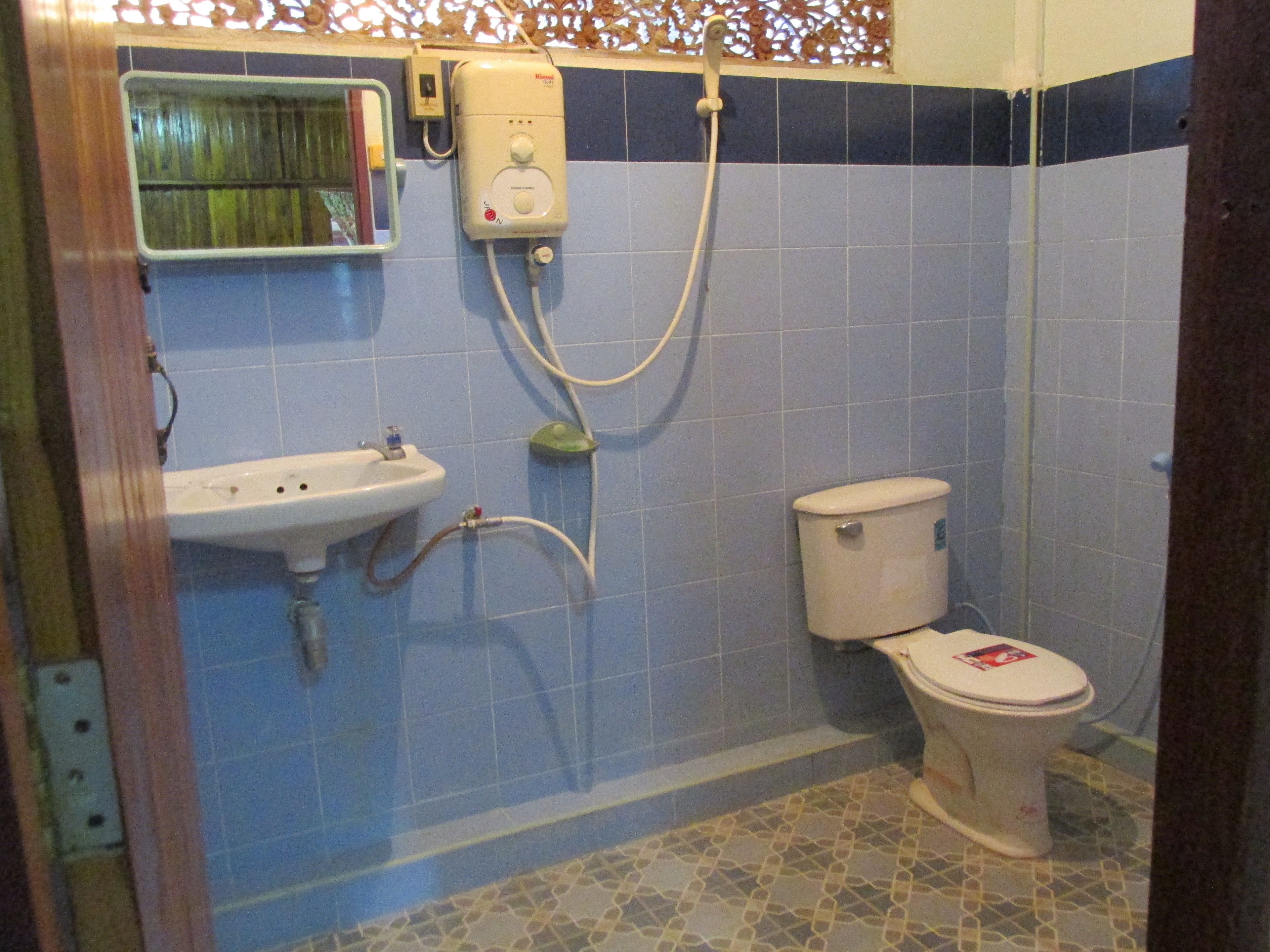 A bathroom with a sink, toilet, and shower.