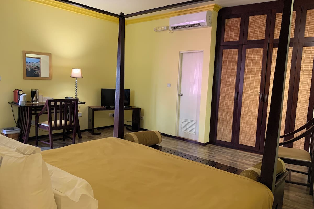deluxe room (with free return airport transfer) | premium bedding, minibar, desk, laptop workspace