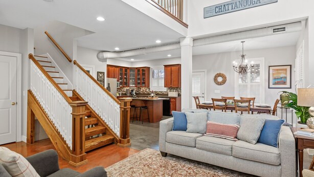 A spacious living area with a staircase, a kitchen, and a dining area. - Elegant Downtown Chattanooga Retreat Near Riverfront & UTC  Sleeps 6 Fireplace (Chattanooga)