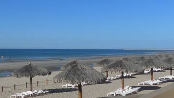 On the beach, sun-loungers, beach towels