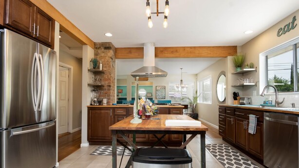 A modern kitchen with stainless steel appliances, wooden cabinets, and a central island. - Beautiful Home in Old Town Cottonwood WALK to Wine Tasting Rooms & Restaurants! (Cottonwood)