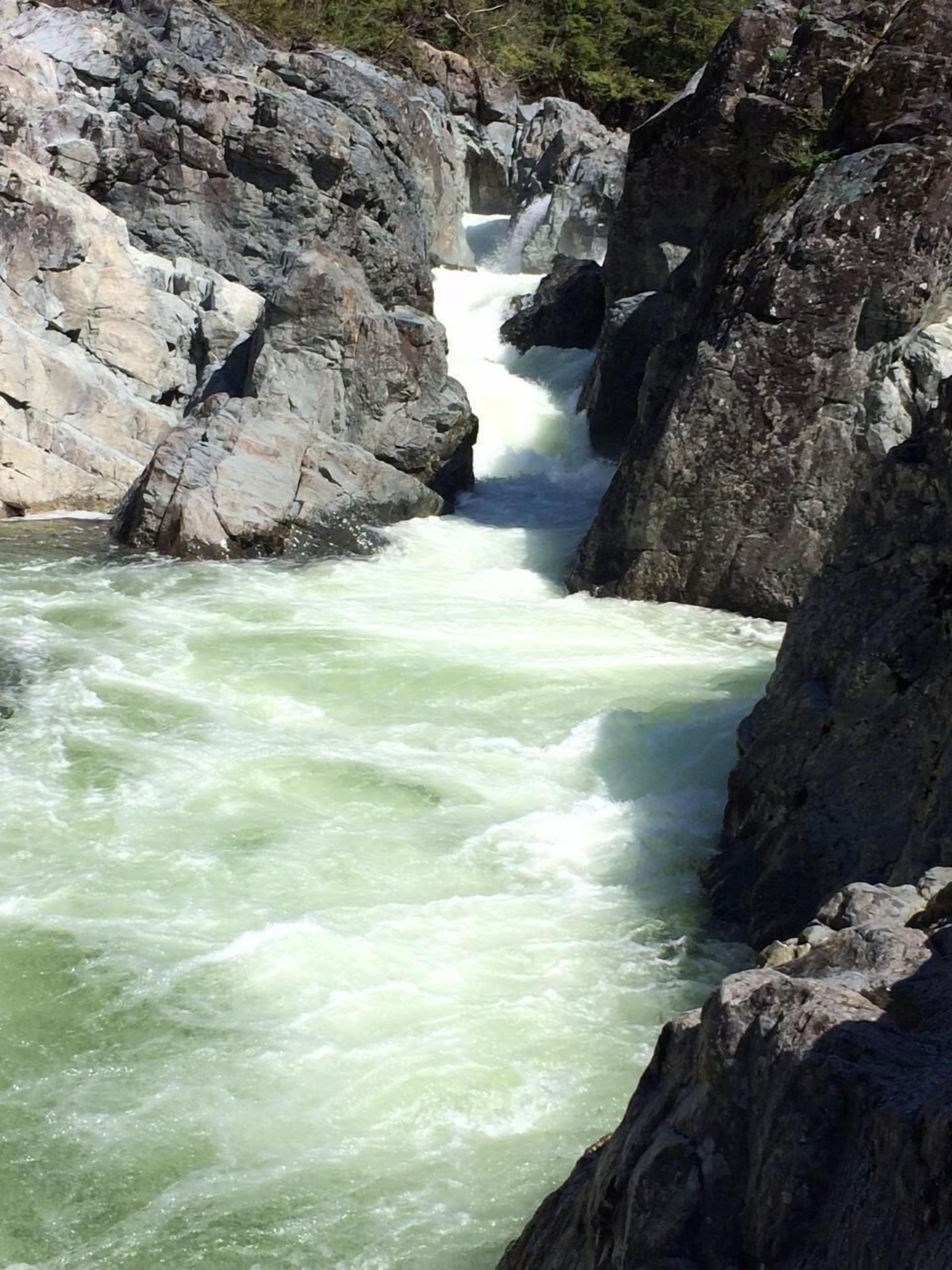 A waterfall surrounded by rocky terrain.