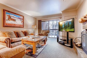 A living room with a sofa, coffee table, and a television. - Walkable to Town Lift | Hot Tub and Fire Pits | Managed by Park City Lodging (PARK CITY)