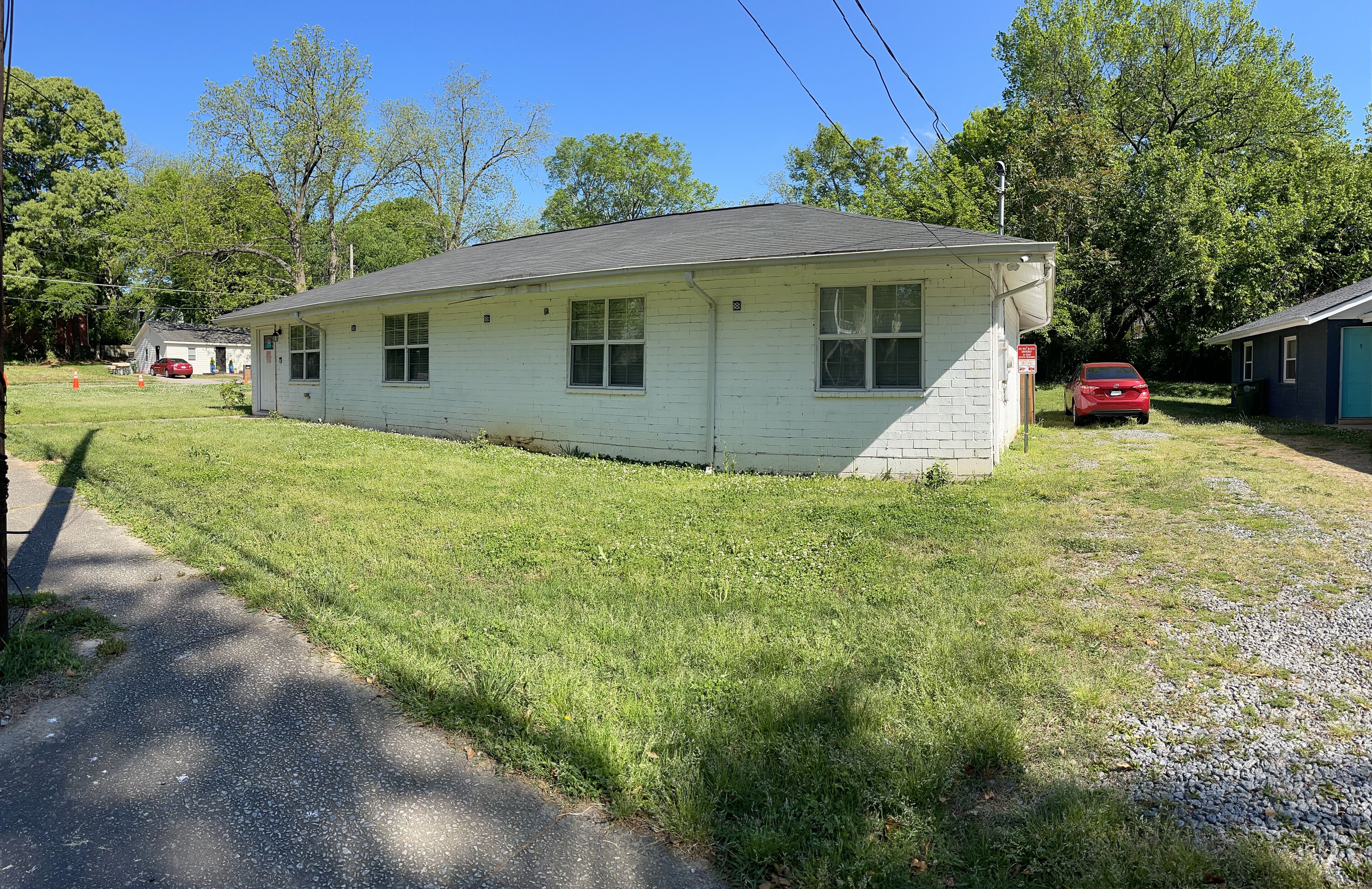 A single-story house with a sloped roof, a front porch, and a small front yard.