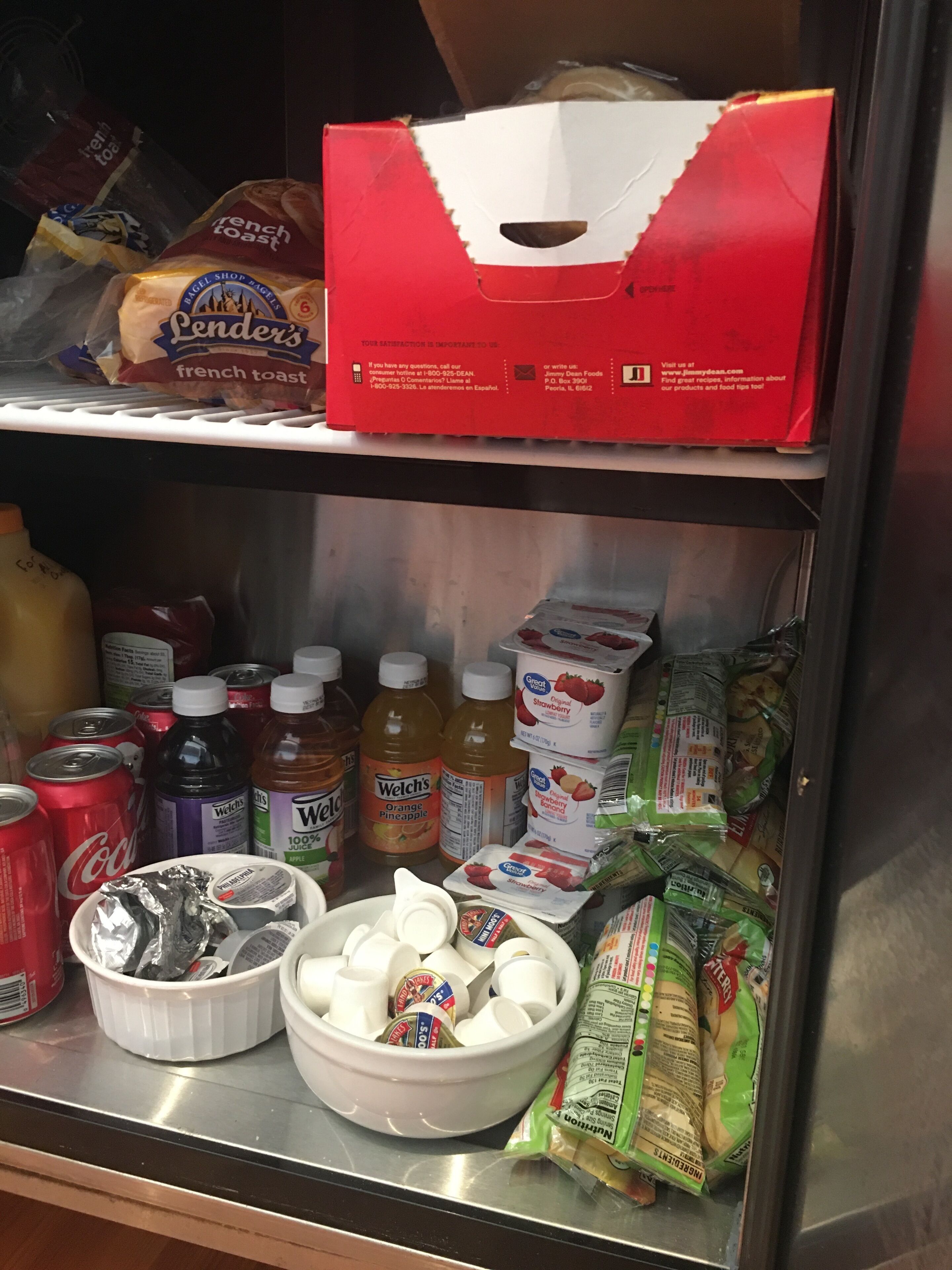 A refrigerator stocked with various food items including bread, condiments, and beverages.