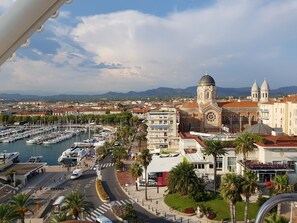A marina with boats, a prominent church with domes, and a casino named Casino Barriere.