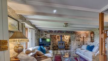 Ground floor: Large characterful sitting room with wood burning stove