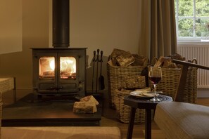 Cozy retreat with a wood-burning stove, comfortable seating area, and a perfect spot for unwinding.