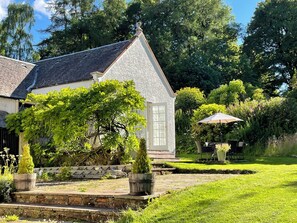 Enjoy a peaceful retreat in this charming single-story home surrounded by a lush garden and a serene patio area.