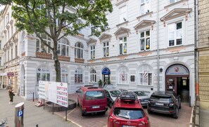 A building with multiple windows and a signboard.