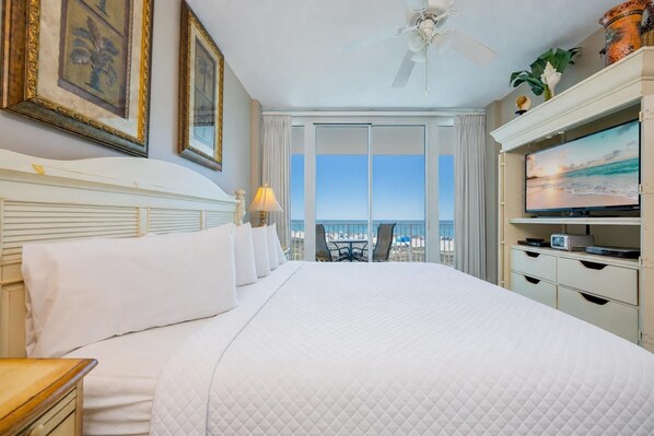 A hotel room with a large bed, a television, and a balcony with a view of the beach. - LIGHTHOUSE! One Bedroom XTRA BATH! Low Floor Beach Front (Gulf Shores)