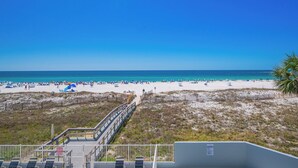 A beach with a wooden boardwalk leading to the water, sandy beach, and clear blue sky. - LIGHTHOUSE! One Bedroom XTRA BATH! Low Floor Beach Front (Gulf Shores)