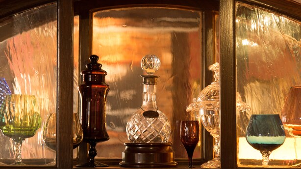 A display of glassware including a decanter, wine glasses, and a crystal decanter. - The Old Vine (Winchester)