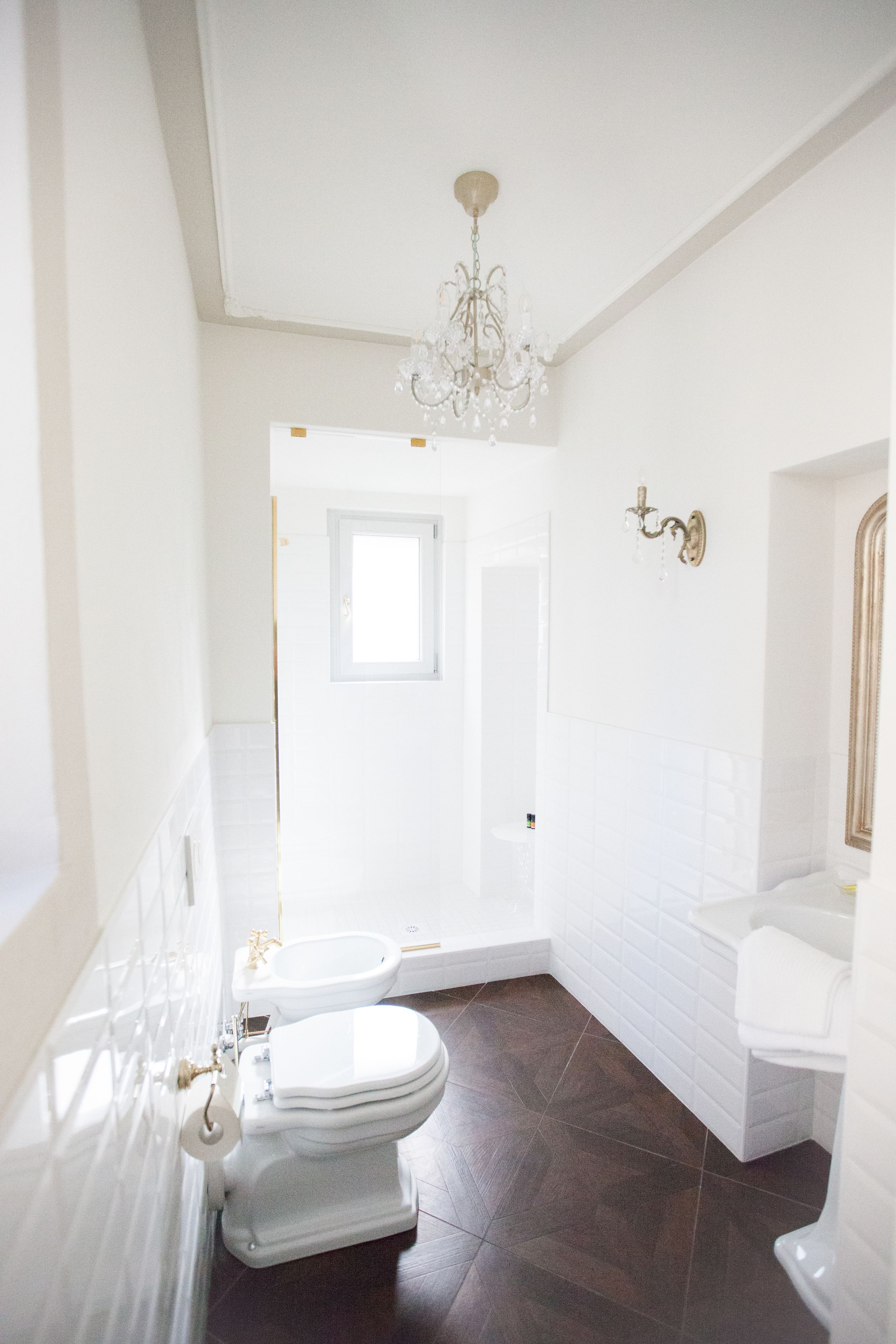 A bathroom with a white toilet, a bidet, and a bathtub.