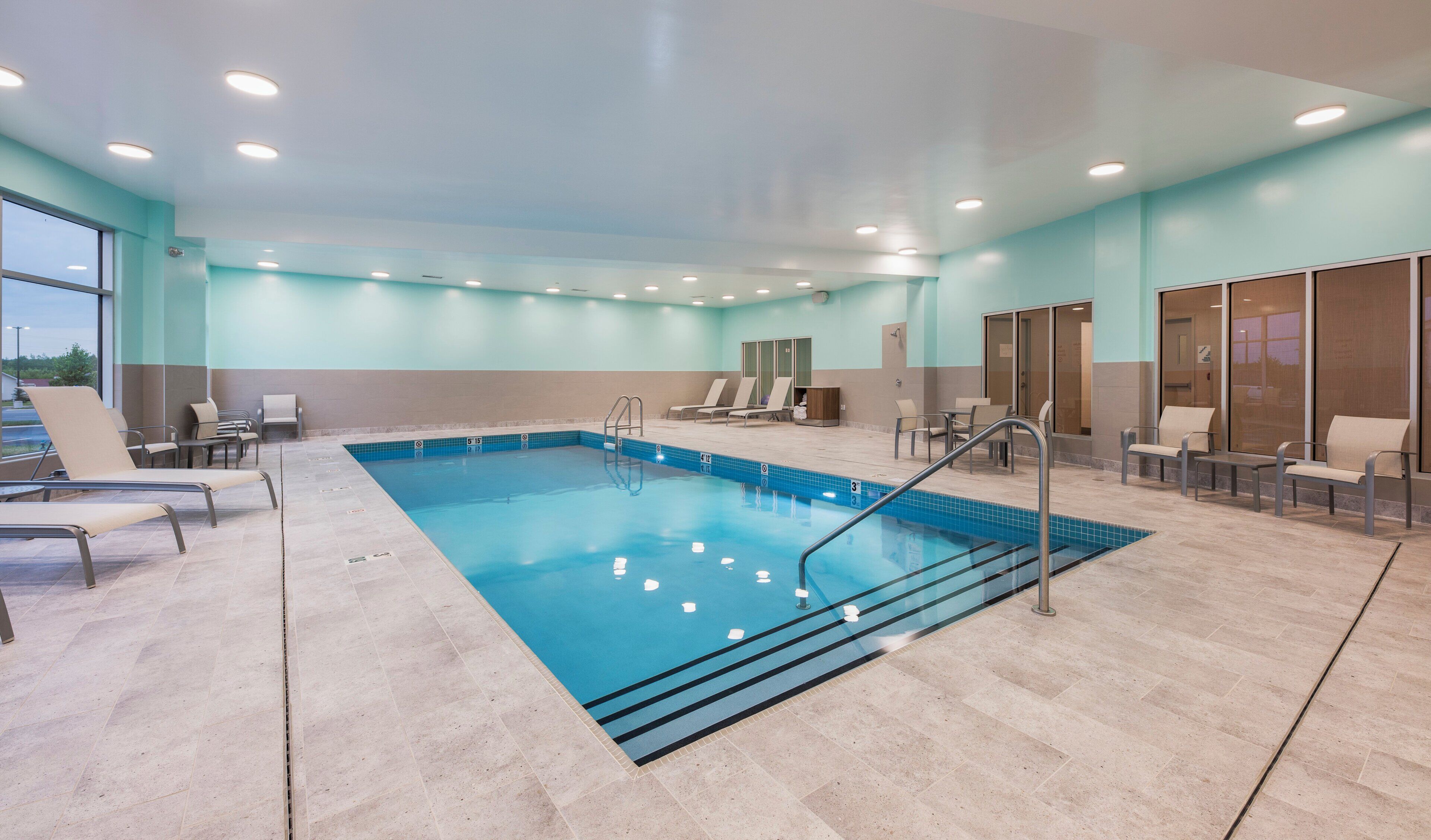 Ein Schwimmbecken mit Liegestühlen und einem Umkleideraum.
